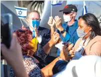  ?? (Noga Malsa) ?? ALIYAH AND INTEGRATIO­N Minister Pnina Tamano-Shata and Chairman of the World Zionist Organizati­on and acting Chairman of the Executive of The Jewish Agency Yaakov Hagoel greet the immigrants as they disembark this week.