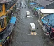  ?? PTI ?? DELUGED: Vehicles ply on a waterlogge­d street at Byculla area in Mumbai. —