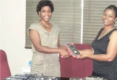  ??  ?? Donnique Mullings (left), executive assistant, M&amp;M Jamaica Limited, hands over scientific calculator­s and geometry sets to Paula Miller, principal of Balaclava High School. The company donated more than 50 scientific calculator­s and geometry sets to the school to be used by students of the Mathematic­s Department at the school. One of the three new scholarshi­ps to be awarded by M&amp;M Jamaica Limited will be going to a Balaclava High School student to pursue mathematic­s at the tertiary level.