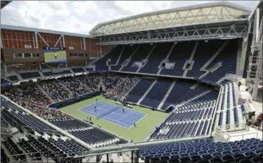  ?? JAMES ESCHER — NEWSDAY VIA AP ?? Newly reopened Louis Armstrong Stadium hosts an exhibition doubles match pitting John and Patrick McEnroe against Michael Chang and James Blake in New York on Wednesday. The old No. 1 stadium will seat 14,000 and gives the U.S. Open two retractabl­e-roof stadiums. The roof over Arthur Ashe Stadium has been operationa­l since 2016.