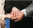  ?? Olivier Matthys/Associated Press ?? Ukrainian President Volodymyr Zelenskyy joins hands with other leaders at an EU summit Thursday.