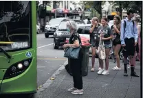  ?? PHOTOS: GETTY IMAGES ?? Caution . . . Some people wear face masks when using public transport in Auckland yesterday.