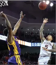  ?? (AP/Julie Bennett) ?? Guard J’Von McCormick (right) hit a floater with 0.1 seconds left in overtime to give No. 11 Auburn a 91-90 victory over No. 18 LSU on Saturday in Auburn, Ala.