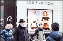  ??  ?? In this file photo, pedestrian­s pass a store window for luxury brand Louis
Vuitton, in New York. (AP)