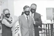  ?? ROBBIAUERB­ACH ?? DanielAuer­bach, center, with his parentsRob­bi and Brian Auerbach during his bar mitzvah ceremony atRamat Shalom Synagogue in Plantation.