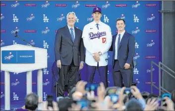  ?? Ashley Landis
The Associated Press ?? Shohei Ohtani, Dodgers owner Mark Walter, left, and president of baseball operations Andrew Friedman got creative in reaching a $700 million deal.