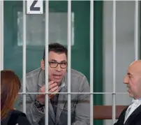  ?? AFP ?? Valentino Talluto speaks with his lawyers during his trial in the courtroom of the Rebibbia prison, Italy. —