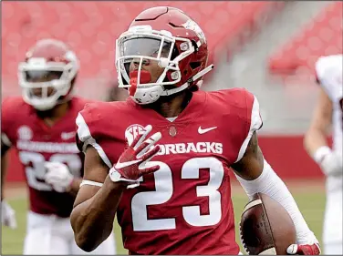  ?? NWA Democrat-Gazette/ANDY SHUPE ?? Arkansas freshman cornerback Devin Bush, shown returning an intercepti­on for a touchdown during the Razorbacks’ spring game in April, plans to major in finance when classes begin in the fall. “I plan on having like an empire,” he said.