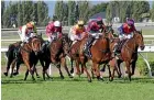  ?? TRISH DUNELL ?? Toms forges clear in the Feilding Cup yesterday.