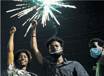  ?? Picture: GETTY IMAGES / AFP / BRANDON BELL ?? JOYFUL: Members of the Oromo community watch fireworks as they gather to celebrate the life of musician and revolution­ary Hachalu Hundessa at the Oromo Community Center in St Paul, Minnesota, US.