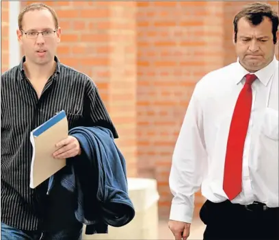  ?? PHOTOGRAPH: MIKE HOLMES ?? ON BAIL: Murder accused Nathan Lewis (left) and his attorney Ryno Scholtz leave court in Port Elizabeth after being granted bail