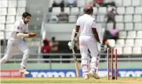  ??  ?? ROSEAU: West Indies batsman Shane Dowrich is bowled out for 20 off the bowling of Mohammad Amir of Pakistan (L) during the fourth days of play of the 3rd and final test match at the Windsor Park Stadium. — AFP