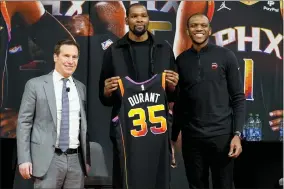  ?? MATT YORK — THE ASSOCIATED PRESS ?? Phoenix Suns forward Kevin Durant, center, holds his jersey after being introduced during an NBA basketball team availabili­ty by owner Mat Ishbia, left, and general manager James Jones, Thursday, Feb. 16, 2023, in Phoenix.
