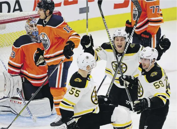  ?? LARRY WONG ?? The Bruins’ Sean Kuraly, centre, celebrates a goal with teammates Noel Acciari, left, and Tim Schaller during Boston’s 3-2 come-from-behind victory over the Oilers Tuesday at Rogers Place, a game the Oilers led 2-0 heading into the third period.