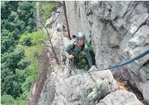  ??  ?? Guide Adam Happensack crosses the Old Ladies Traverse, a ledge high on the east face of Seneca Rocks.