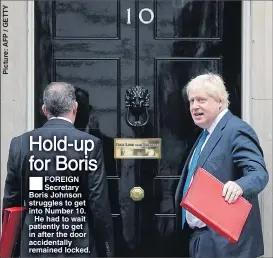  ??  ?? FOREIGN Secretary Boris Johnson struggles to get into Number 10.
He had to wait patiently to get in after the door accidental­ly remained locked.