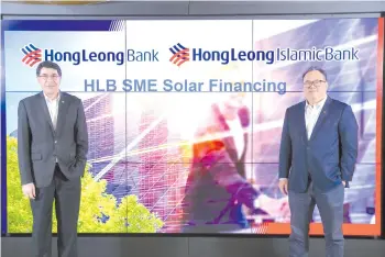  ??  ?? Fuda (left) poses with Yow for a photo opt during the launch of ‘HLB SME Solar Financing’.