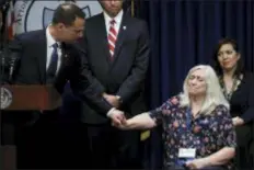  ?? ASSOCIATED PRESS ?? Pennsylvan­ia Attorney General Josh Shapiro holds hands with Judy Deaven, who says her son was a victim of sexual abuse by a priest as a boy, during a news conference at the Pennsylvan­ia Capitol in Harrisburg. A Pennsylvan­ia grand jury says its investigat­ion of clergy sexual abuse identified more than 1,000 child victims. The grand jury report says that number comes from records in six Roman Catholic dioceses.