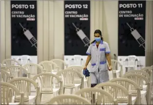  ?? ARMANDO FRANCA — THE ASSOCIATED PRESS ?? A worker disinfects chairs at a new vaccinatio­n center in Lisbon on Tuesday. It will take a while before anyone knows how dangerous the omicron variant is.