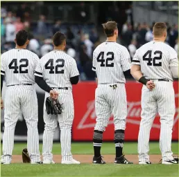  ??  ?? The New York Yankees take the field wearing No. 42 in honor of Jackie Robinson during a game against the Boston Red Sox at Yankee Stadium in New York on April 16, 2019.