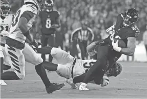  ?? PATRICK SMITH/GETTY IMAGES ?? The Ravens’ Mark Andrews (89) is tackled by the Bengals’ Logan Wilson using a hip-drop technique.