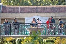  ?? AP PHOTO/BRANDEN CAMP ?? People visit the eternal flame at the tomb of Martin Luther King Jr. and his wife Coretta Scott King on Monday in Atlanta to observe the Martin Luther King Jr. holiday.