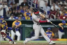  ?? WILFREDO LEE – THE ASSOCIATED PRESS ?? Trea Turner of the United States hits a go-ahead grand slam during the eighth inning of Saturday's World Baseball Classic quarterfin­al game against Venezuela in Miami.