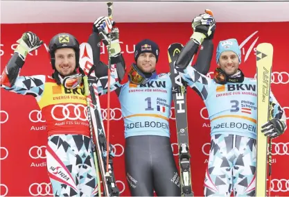  ??  ?? ADELBODEN: From left, Austria’s Marcel Hirscher, second placed, France’s Alexis Pinturault, the winner, and third placed Philipp Schoerghof­er, of Austria, celebrate on podium after an alpine ski, men’s World Cup giant slalom in Adelboden, Switzerlan­d,...