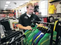  ?? AP PHOTO/DAVE MARTIN ?? In this June 25, 2008, file photo, Reece Armistead, an assistant manager at Hibbett Sports in Thomasvill­e, Ala., sorts clothing at the store. Hibbett, a chain with more than 1,000 stores, said it expects a key sales figure to fall due to a...