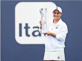  ?? GEOFF BURKE/USA TODAY SPORTS ?? Ashleigh Barty of Australia holds the Butch Bucholz Trophy after winning the women’s singles final in the Miami Open.