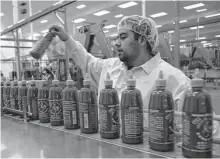  ?? Irfan Khan/TNS ?? David Tran, owner of Huy Fong Foods Inc., produces Sriracha sauce in Irwindale, Calif., in 2015. The hot sauce is in short supply due to a drought in northern Mexico.