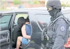  ?? AFP ?? This photo taken and released by the New South Wales Police yesterday shows a man, left, being arrested during a counter-terrorism operation in Sydney.