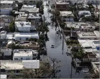  ?? Bloomberg photo by Alex Wroblewski. ?? A vehicle drives through streets filled with floodwater after Hurricane Maria in San Juan, Puerto Rico, last year.