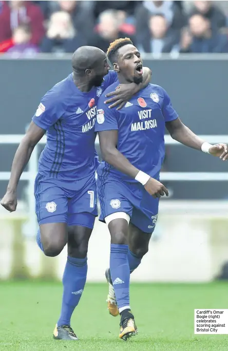  ??  ?? Cardiff’s Omar Bogle (right) celebrates scoring against Bristol City