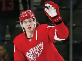  ?? DUANE BURLESON — THE ASSOCIATED PRESS ?? Detroit Red Wings’ Moritz Seider waves to Little Caesars Arena fans after scoring in overtime to defeat the New York Islanders Saturday. Detroit hosts Nashville Tuesday.