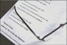  ??  ?? Truax’s reading glasses rest on a printout of one of her poems.
