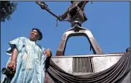  ?? ?? Ntuli stands next to a statue of the ‘Silverton Three’, a monument celebratin­g three struggle heroes killed by apartheid police. /Gallo Images