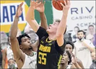  ?? James Franco / Special to the Times Union ?? Jackson Stormo goes up strong in front of Manhattan’s Warren Williams during their game Saturday. Stormo finished the game with a career-high 18 points for the Saints.