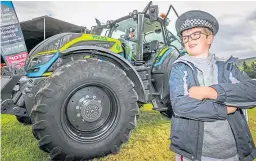  ??  ?? The four-day festival will feature internatio­nal event classes, the Scottish Grassroots Eventing Festival, cross country, a pony show, showjumpin­g and mounted games. A crime-busting tractor, seen with Paddy Phillips, 9, above, will also be on show.
