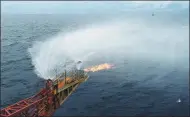  ?? XINHUA ?? Combustibl­e ice is seen burning on an ultra-deep-water semisubmer­sible drilling rig near the coast in Zhuhai, Guangdong province, recently.