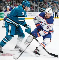  ?? GODOFREDO A. VÁSQUEZ/ASSOCIATED PRESS ?? Edmonton center Connor Mcdavid (97) takes the puck away from San Jose defenseman Matt Benning during a Jan. 13 game. The MVP candidate will try to help the Oilers take the next step in this season’s playoffs, where they were swept in the West final last year.