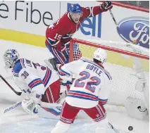  ?? JOHN KENNEY/MONTREAL GAZETTE ?? Montreal’s Tomas Fleischman­n celebrates his second-period goal against the Rangers’ Henrik Lundqvist while defenceman Dan Boyle looks on Thursday night at the Bell Centre.