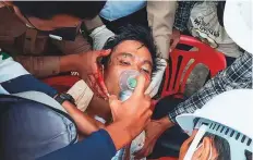  ?? AFP ?? An injured man being treated by medical officials after a crackdown by security forces in the city of Dawei.