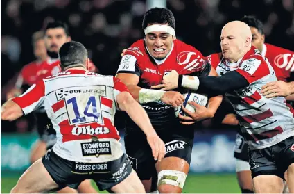  ??  ?? Tough encounter: Selevasio Tolofua is tackled by Gloucester scrum-half Joe Simpson (right), who scored two tries