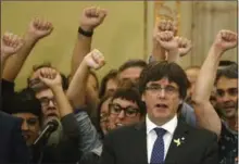  ?? MANU FERNANDEZ, THE ASSOCIATED PRESS ?? Carles Puigdemont sings the Catalan anthem inside the parliament building after a vote on independen­ce in Barcelona, Spain.