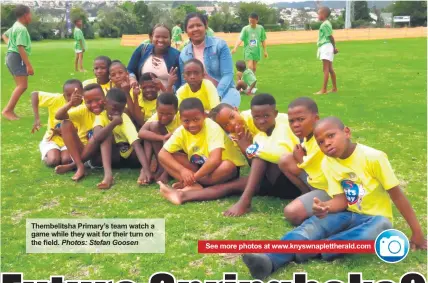  ?? Photos: Stefan Goosen ?? Thembelits­ha Primary’s team watch a game while they wait for their turn on the field.