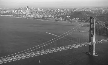  ??  ?? Cars travel across the Golden Gate Bridge in this aerial photograph taken above San Francisco, California, on Oct 5, 2015.