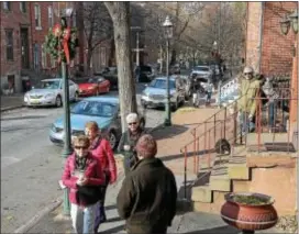  ??  ?? People walk along Mercer st during the 51st Annual Mill Hill Holiday House Tour.