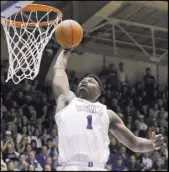  ?? Gerry Broome The Associated Press ?? Duke forward Zion Williamson soars to the basket Saturday in the second half of the No. 1 Blue Devils’ 72-70 win over No. 4 Virginia at Cameron Indoor Stadium.