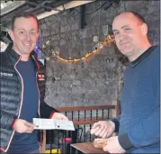  ?? (Pic: John Ahern) ?? INDIE22 supporter, Kieran Duggan, purchasing his weekend camping tickets from Mark Noonan in Walsh’s Bar, Mitchelsto­wn last Saturday morning.